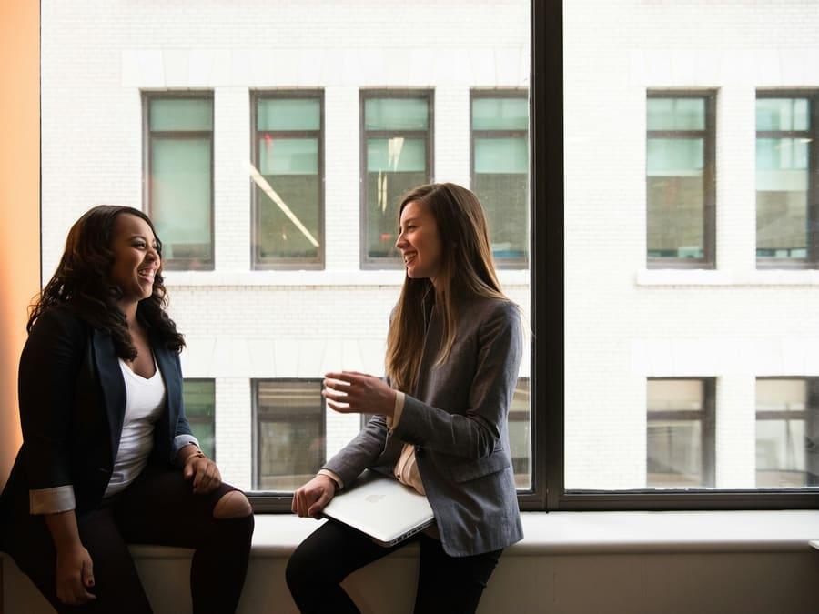 Two colleagues talking in a bright office