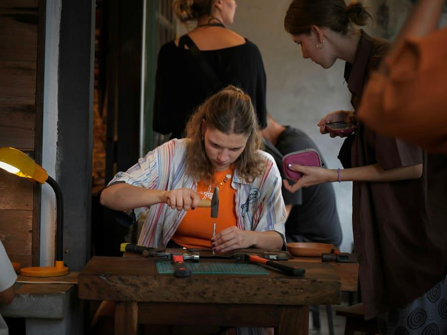 A student learning a hands-on craft in a workshop