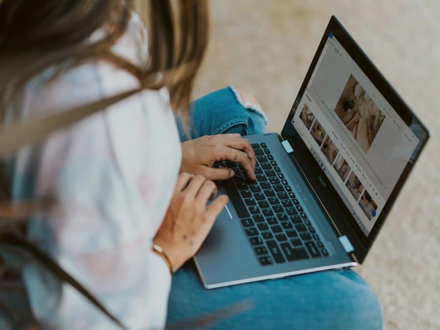 A student working on a creative project on a laptop